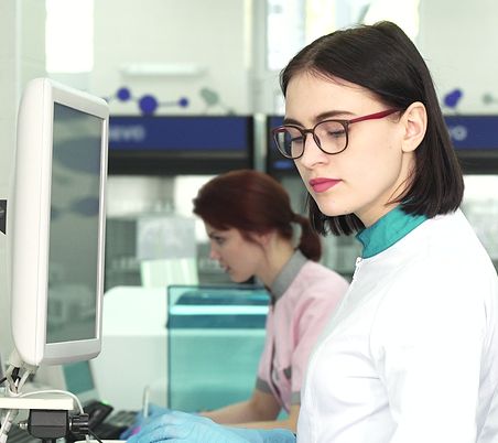 Person using computer wearing gloves.